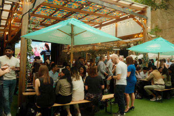 people sitting in a covered beer garden in london