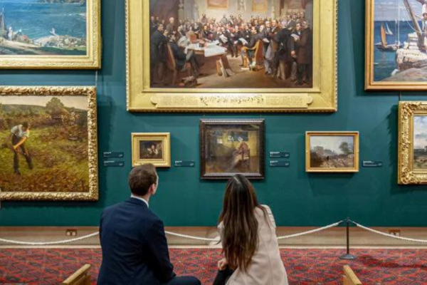 to people sitting on a bench gazing at artwork at guildhall art gallery