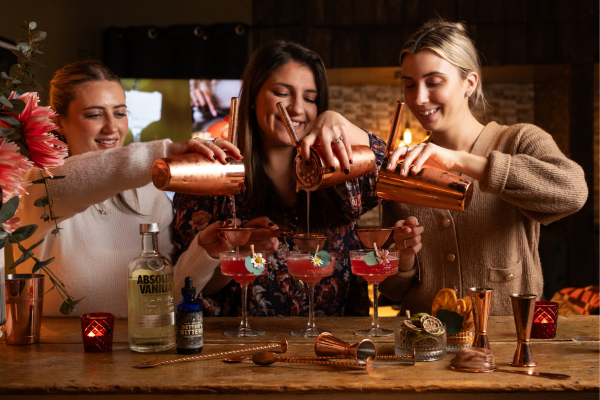 Three people making cocktails
