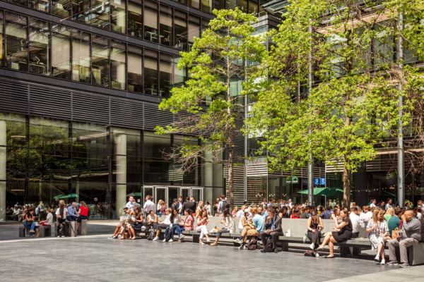 people sitting outside on new street square in the sun